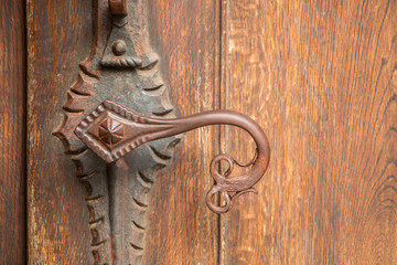 Door handle of an old historical building made of iron