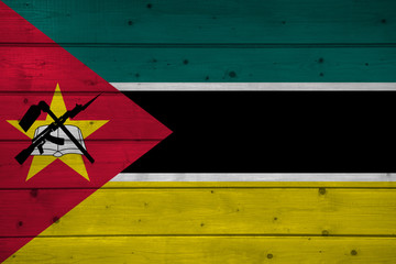 Naklejka premium Flag of Mozambique on wooden background, surface. Wooden wall, planks. National flag