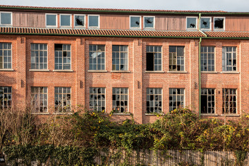 Old destroyed brick house ruin with broken windows