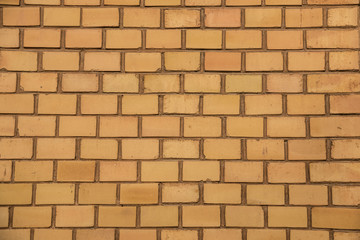 Old empty brick house factory wall with yellow bricks