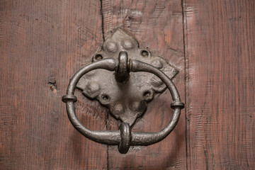 Old door of a historical building with iron door knob