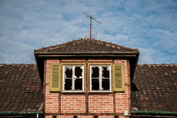 Old destroyed brick house ruin with broken windows