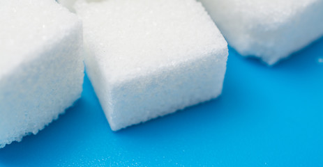 sugar close up over blue background