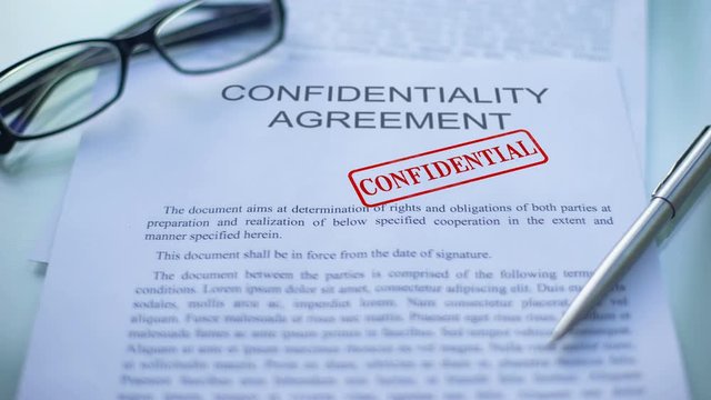 Confidentiality agreement confidential, hand stamping seal on business document