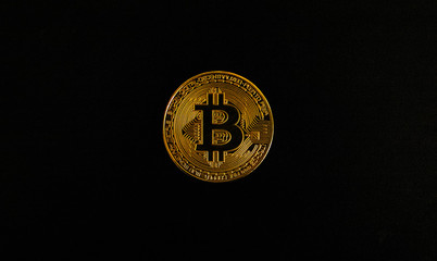 Gold Bitcoin on  black background. Isolate.