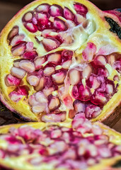 Pomegranate cut in half with seeds detail - Macro photography of the interior of pomegranate