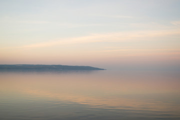 Fototapeta na wymiar Background of mist on sunset over lake. Composition of nature.