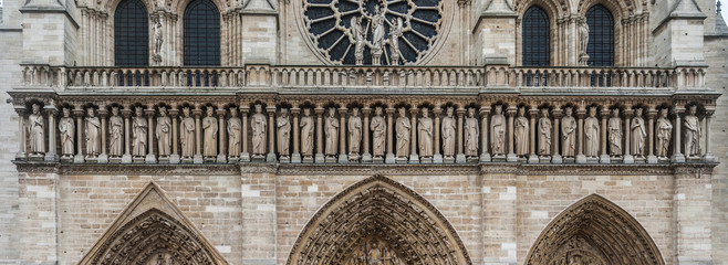 French kings stone statues gallery on the western facade of the Notre-Dame (Our Lady) cathedral of Paris, France.