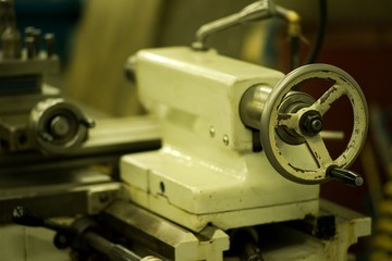 Lathe machine for metal cutting, machinery center background.