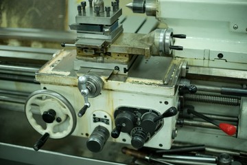 Lathe machine for metal cutting, machinery center background.