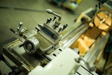 Lathe machine for metal cutting, machinery center background.