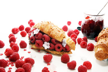 Delicious breakfast with fresh croissants and ripe berries