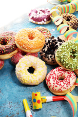 assorted donuts with chocolate frosted, pink glazed and sprinkles donuts