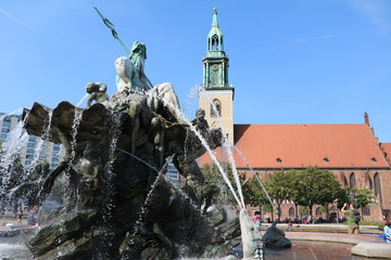 Neptune's Fountain and St. Mary's Church at Alexanderplatz in Berlin, Germany