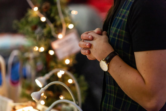 woman crossing hands at christmas event. Close up picture shot indoors in a christmas crafts market
