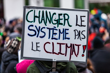 Activists marching for the environment. French sign seen in an ecological protest saying Change the...