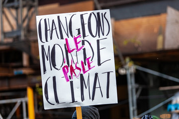 Activists marching for the environment. French sign seen in an ecological protest saying let's change the world, not the climate