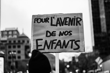 Activists marching for the environment. French sign seen in an ecological protest saying for the future of our kids
