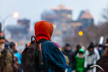 Activists marching for the environment. Young man is looking at the crowd during an ecological...