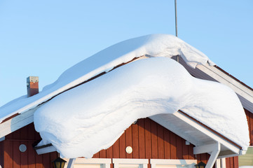 Heavy snow load on canopy roof over the door. © ekim