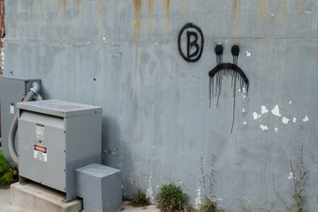 Distressed Blue Wall With Frown Graffiti