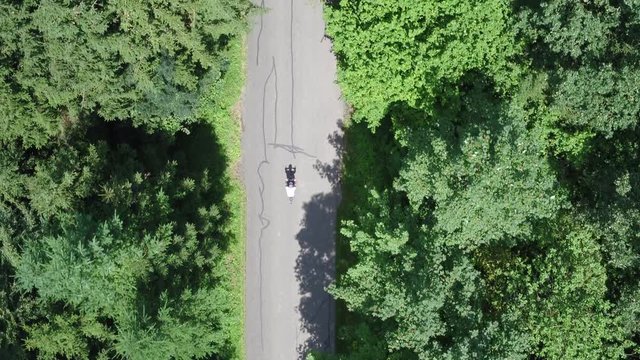  Bike Rider Filmed in Forrest on a road with drone and Top Down Birds Eye Aerial View