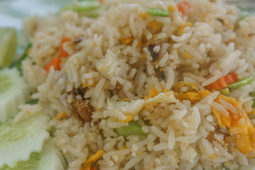 Asian fried rice with eggs, corn and parsley close-up on a plate