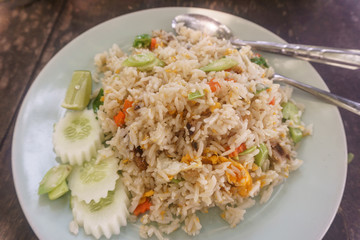 Asian fried rice with eggs, corn and parsley close-up on a plate