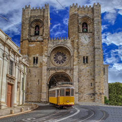 Yellow Tram and Lisbon Cathedral of St. Mary Major (Se de Lisboa) in Alfama district, Lisbon,...