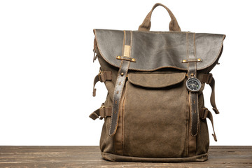 Vintage brown backpack on table with isolated background