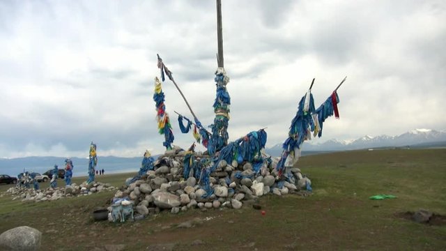 13 shaman obo sacrifices on stones on background of clouds in Mongolia.