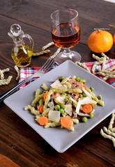 Spinach pasta with spinach and gorgonzola dressing with peas and carrots  