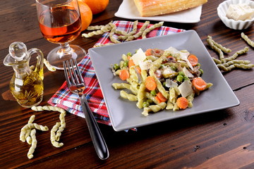 Spinach pasta with spinach and gorgonzola dressing with peas and carrots  