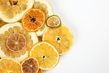Dried slices of various citrus fruits closeup on white background