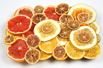 mix of different pieces of dried citrus fruit on white background