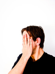 Fototapeta premium Man Covering Face With Hand - Sideview