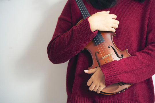 Close up woman holding violin