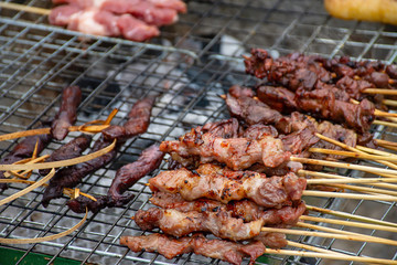Grilled marinated meat with sauce Skewers and small on the steel grilles With the heat.