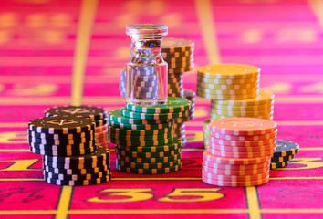 Casino table. American Roulette layout. Dolly is standing on stacks of playing chips.