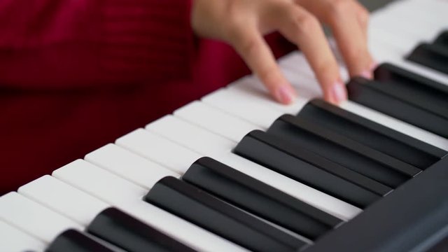 Close up woman hand playing piano