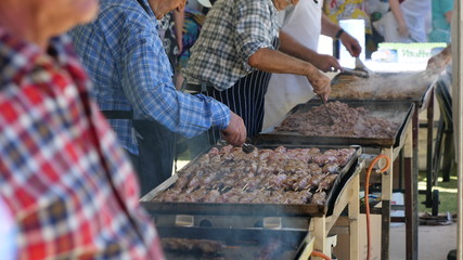 Elderly men cooking BBQ