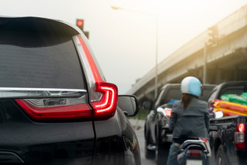 Black car on the road in traffic junction there are many cars on the road.