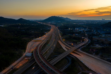 Fototapeta premium Aerial view. Highway intersections and traffic at twilight