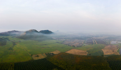 Obraz premium Aerial view of agriculture in the morning with fog and sunshine