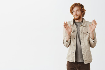 No offence sorry pal. Portrait of intense redhead male with beard feeling awkward smiling tight...