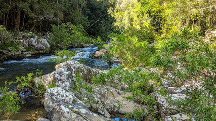 A cool mountain stream runs to a waterfall