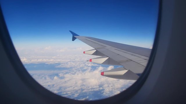 Travel Video View from the Airplane window seat. Twilight view in the early morning reduces speed and landing. Reduce the level of flight to destination with clouds and colorful sky background.
