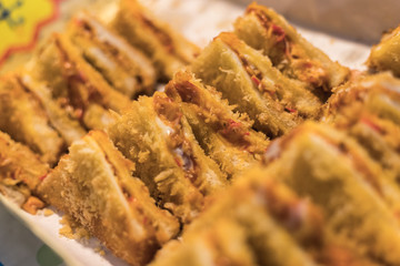 Fried sandwich with some Crab sticks and sauce inside