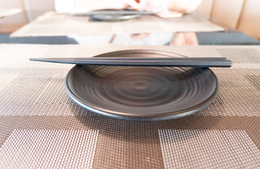 Fototapeta na wymiar on the table Wooden Chopsticks on a Plate.