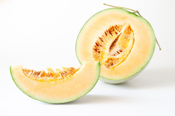 Half and sliced Japanese melons isolated on white background
